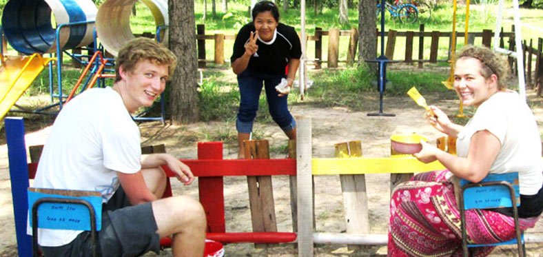 volunteers painting fences