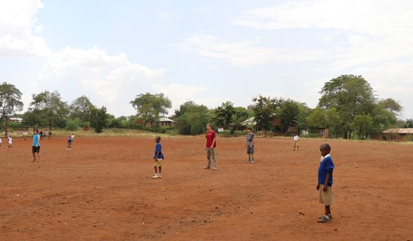 volunteer playing game with kids in south africa