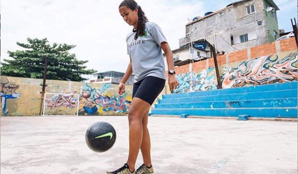 footballer jogging ball on the ground