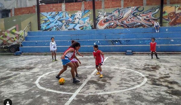 youth playing football brazil