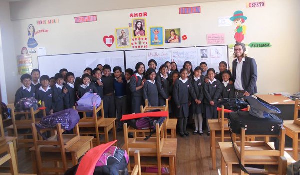 volunteer and students posing for photograph