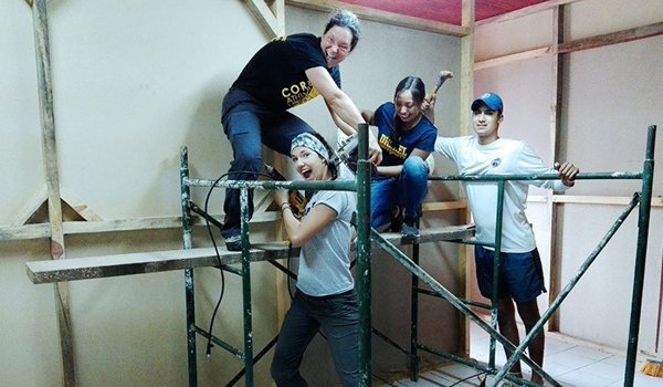 volunteer-having-fun-while-constructing-house