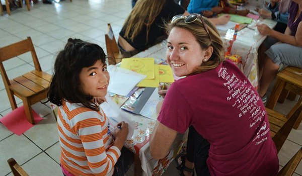 volunteer assisting kids in their homework