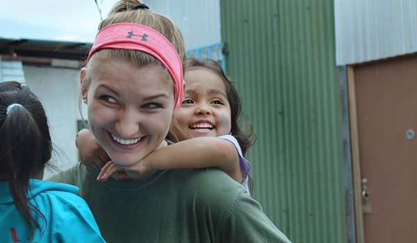 volunteer carrying baby kids