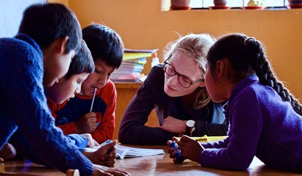 volunteer helping school kids in homework