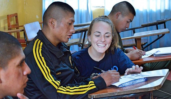 volunteer teaching drawing to student