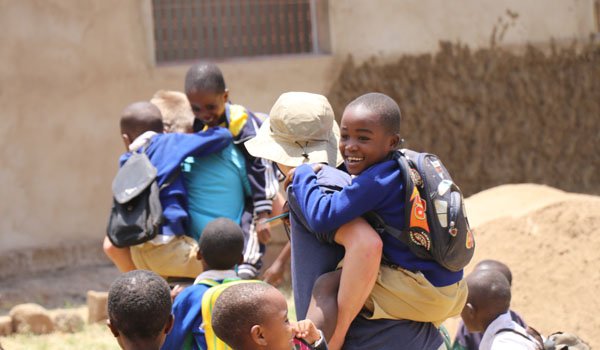volunteer having fun time with kid africa