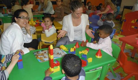 Volunteers playing with kids in morocco 