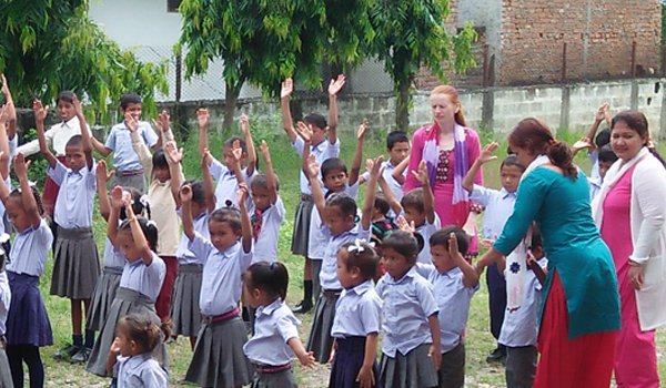 volunteer helping student to teach physical activity