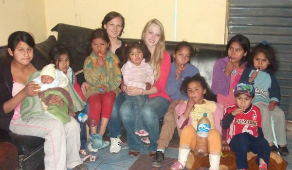 volunteer spending time with orphan kids