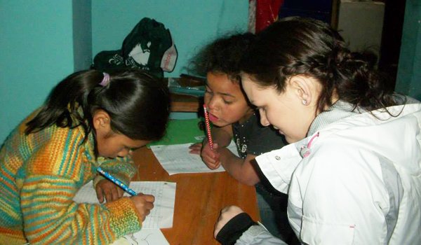 volunteer helping student in their homework