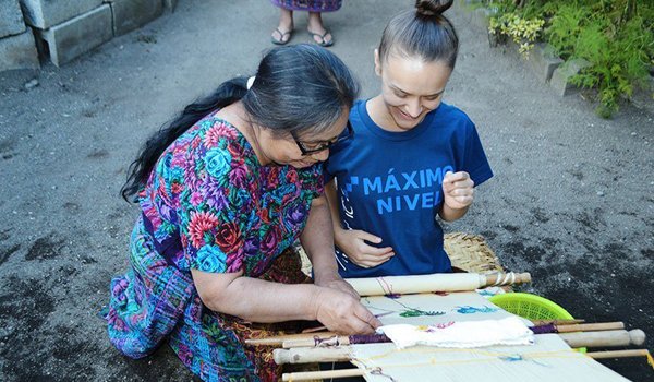 volunteer-take-help-of-elderly-woman-to-understand-local-product
